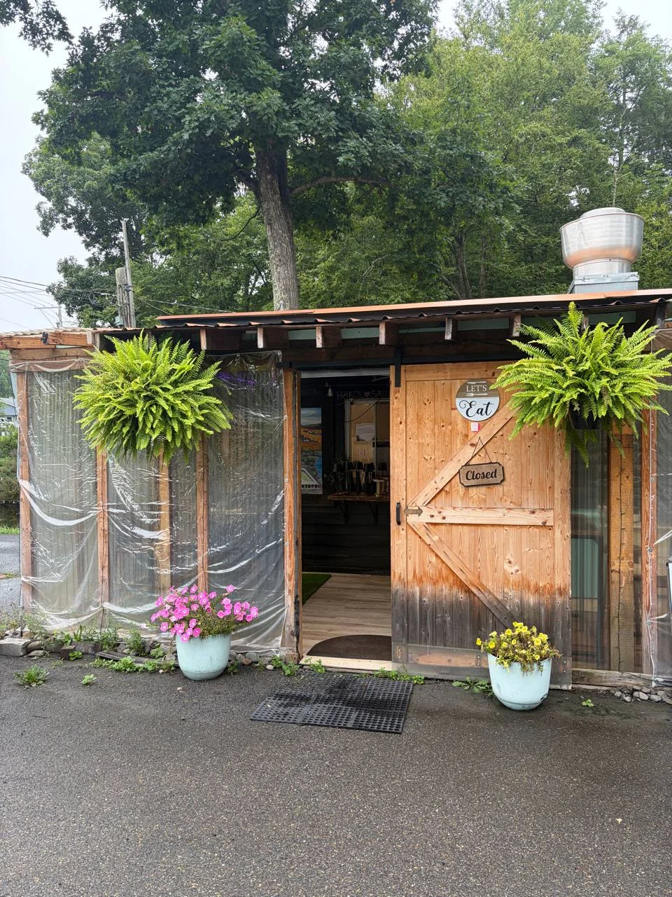 Flower-lined entrance to Koby's creekside venue