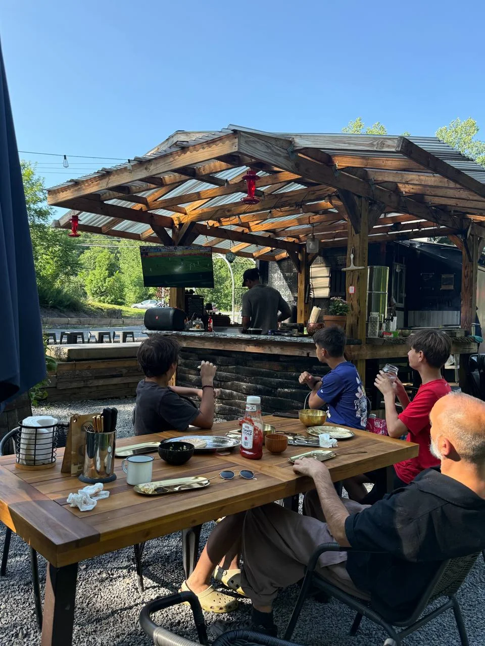 Guests dining beside Koby's outdoor creekside bar
